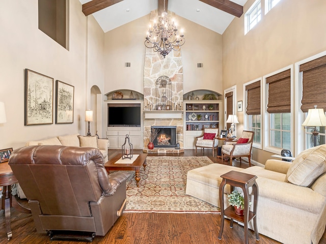 living room with wood-type flooring, a fireplace, beam ceiling, and plenty of natural light