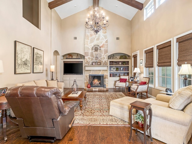7005 Shinnecock Hills Dr, Fort Worth, TX 76132 - living area featuring beamed ceiling, wood finished floors, a fireplace, and an inviting chandelier