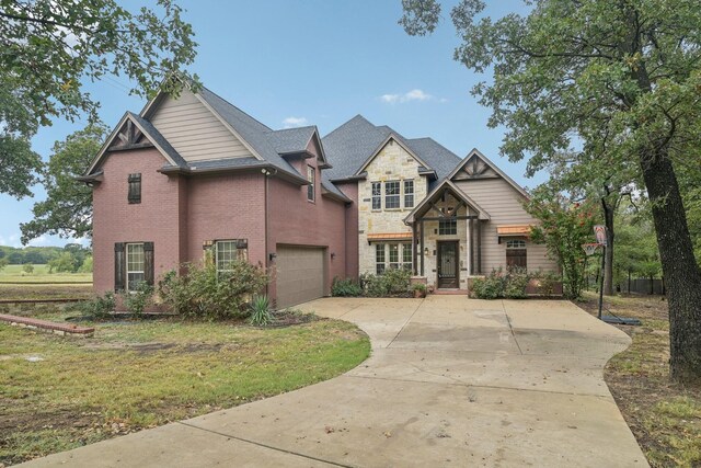 craftsman house featuring a front yard and a garage