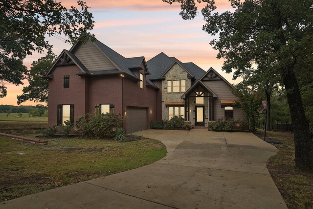 craftsman house featuring a lawn and a garage