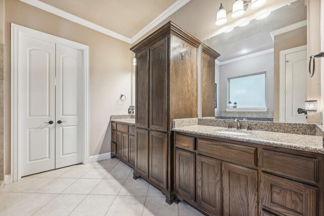 bathroom featuring ornamental molding, vanity, and tile patterned floors