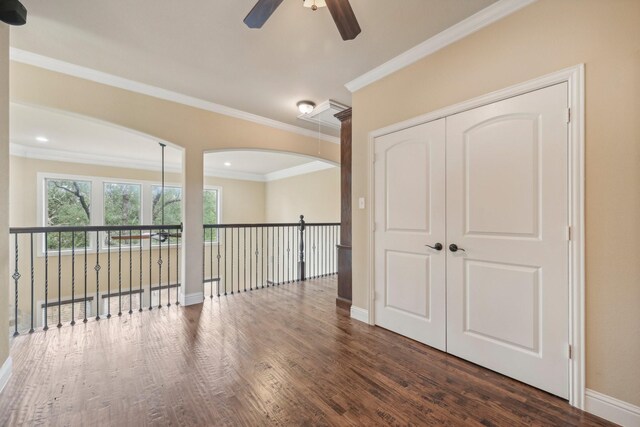 interior space with ornamental molding and dark hardwood / wood-style floors