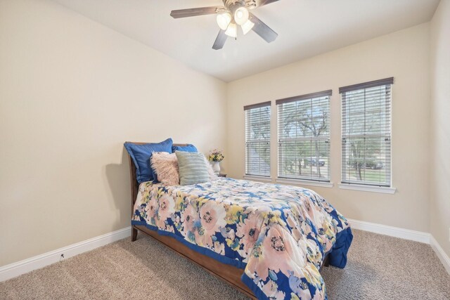 carpeted bedroom featuring ceiling fan and multiple windows