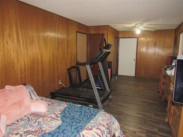 carpeted bedroom with wood walls and ceiling fan