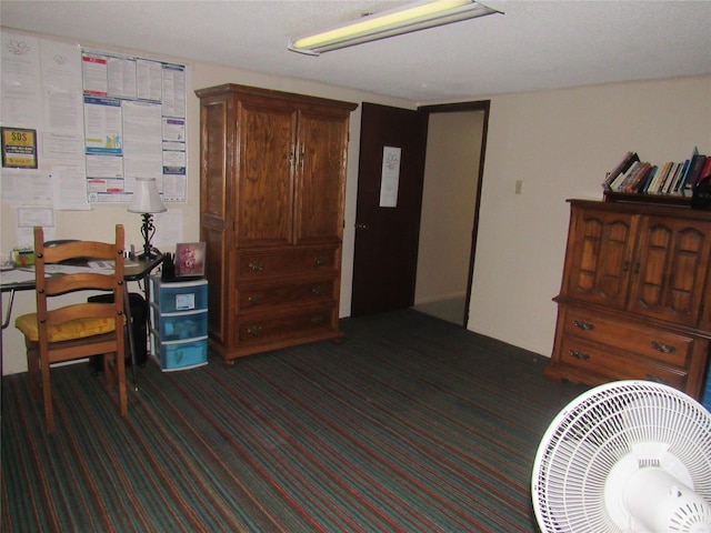 home office featuring dark colored carpet