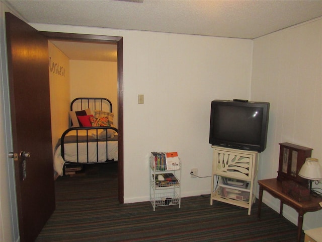 misc room with a textured ceiling and carpet