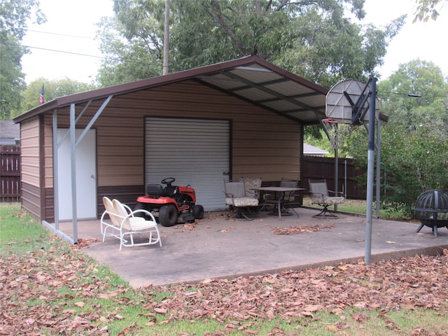 view of outbuilding with an outdoor structure and fence