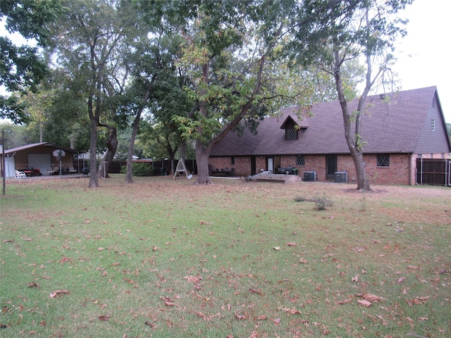 view of yard with cooling unit and a carport