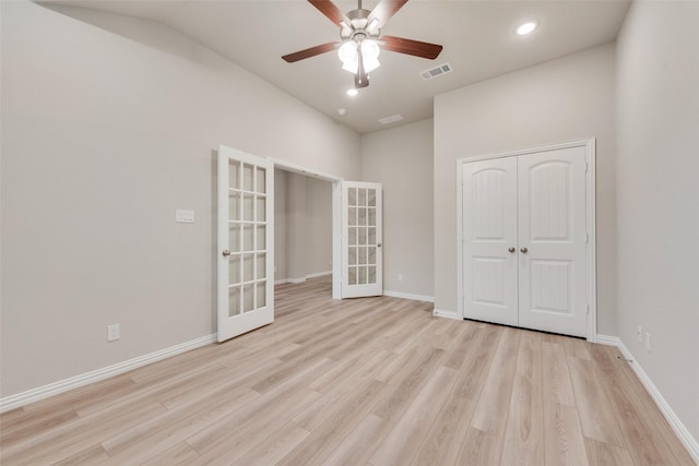 unfurnished room featuring french doors, ceiling fan, lofted ceiling, and light hardwood / wood-style flooring