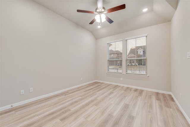 spare room featuring vaulted ceiling, ceiling fan, and light hardwood / wood-style flooring