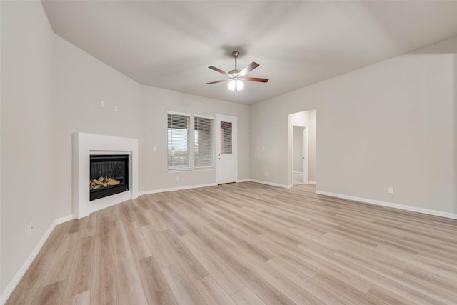 unfurnished living room with ceiling fan and light wood-type flooring