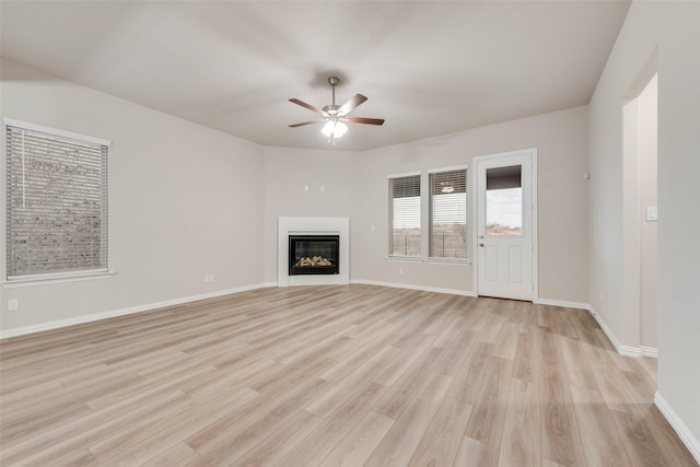 unfurnished living room featuring light hardwood / wood-style floors and ceiling fan