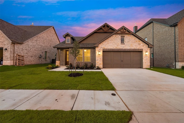 craftsman house with a garage and a lawn