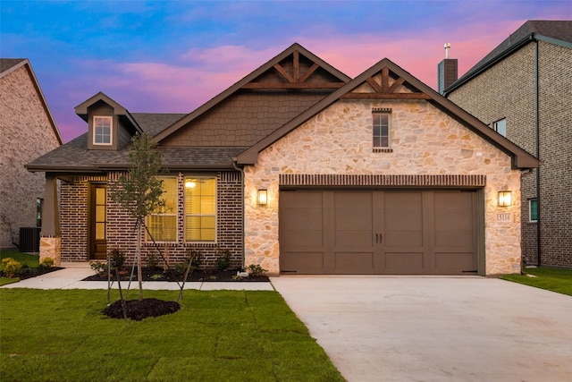 view of front of house featuring a garage, central AC unit, and a lawn