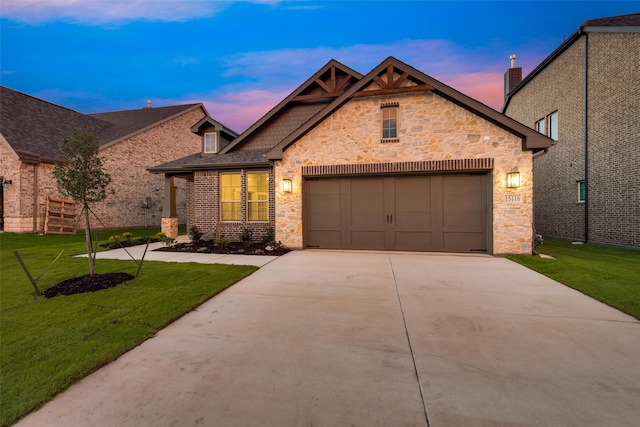 craftsman house featuring a garage and a lawn