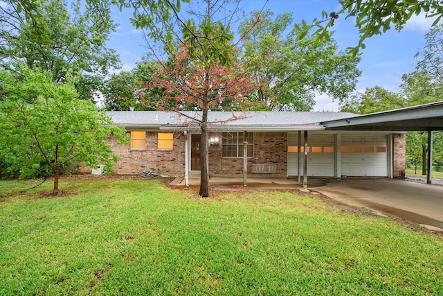 ranch-style house featuring a garage, a carport, and a front lawn