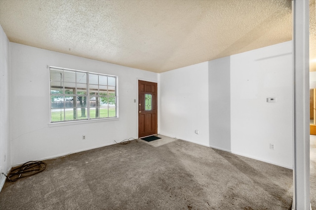 carpeted entrance foyer with a textured ceiling