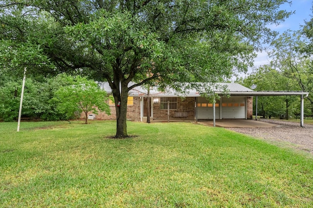 view of yard with a carport and a garage