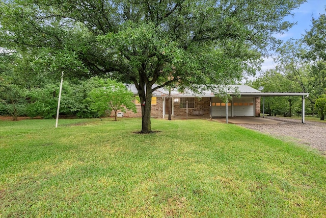 view of yard featuring a carport and a garage