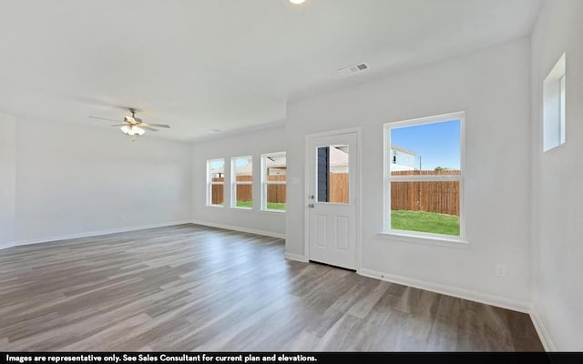 interior space featuring ceiling fan, hardwood / wood-style flooring, and a healthy amount of sunlight