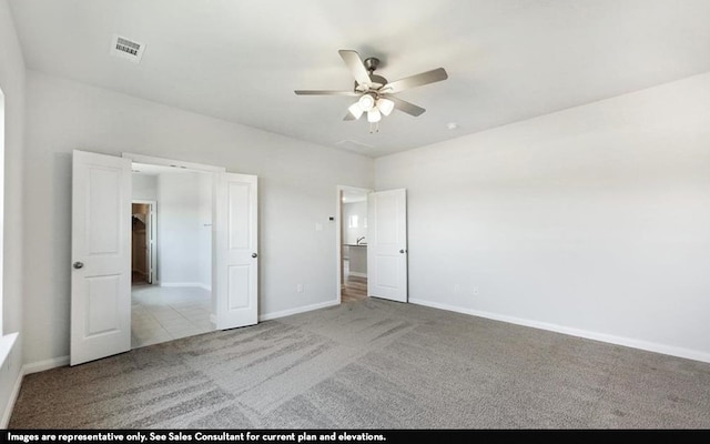 unfurnished bedroom featuring light carpet and ceiling fan