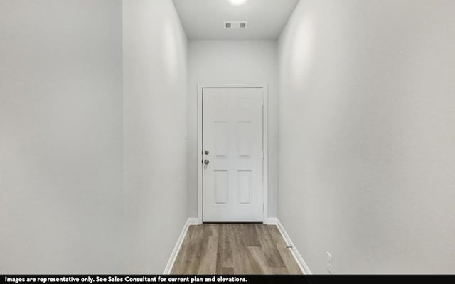 hall with hardwood / wood-style flooring