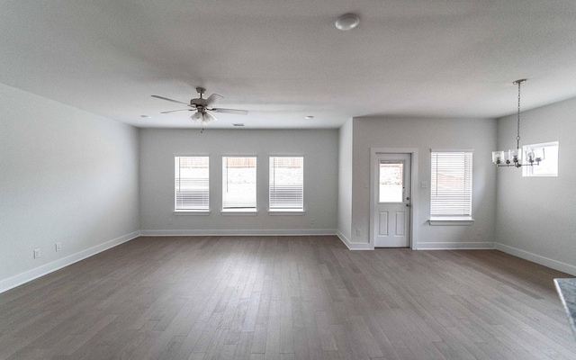 interior space with plenty of natural light, baseboards, and wood finished floors