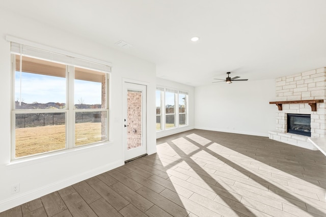 unfurnished living room with ceiling fan, dark hardwood / wood-style floors, and a fireplace