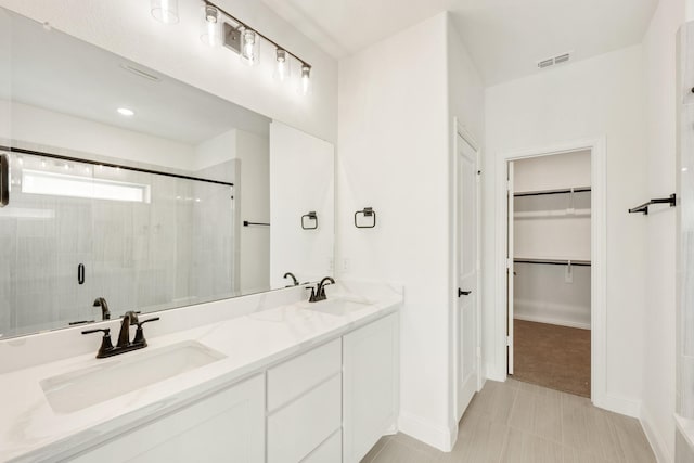 bathroom featuring tile patterned floors, vanity, and an enclosed shower