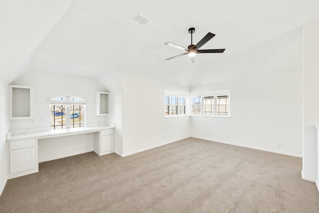 unfurnished living room with ceiling fan, light colored carpet, and vaulted ceiling