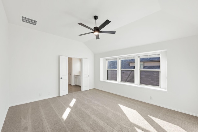 unfurnished bedroom with ceiling fan, light carpet, and vaulted ceiling