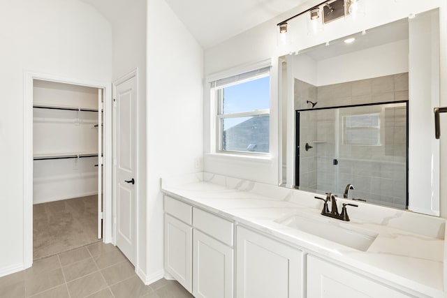 bathroom with tile patterned flooring, vanity, and a shower with shower door