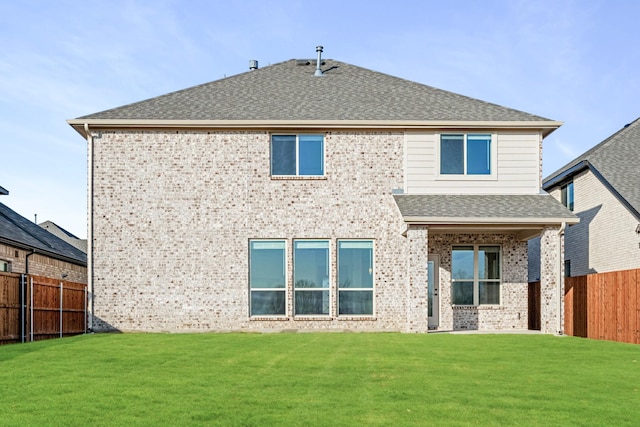 rear view of property with a lawn