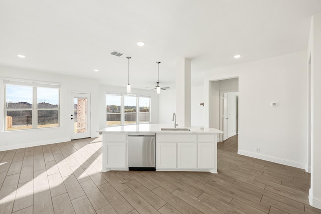 kitchen with dishwasher, sink, decorative light fixtures, a kitchen island with sink, and white cabinets