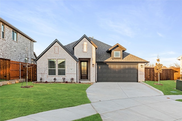 view of front of home with a garage and a front lawn