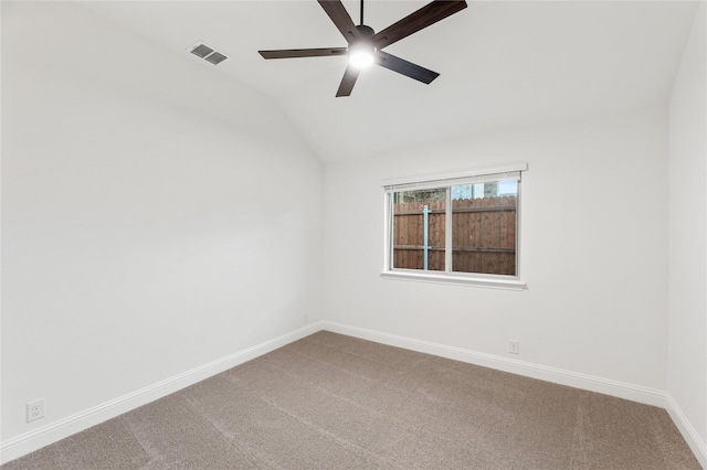 carpeted empty room with vaulted ceiling and ceiling fan