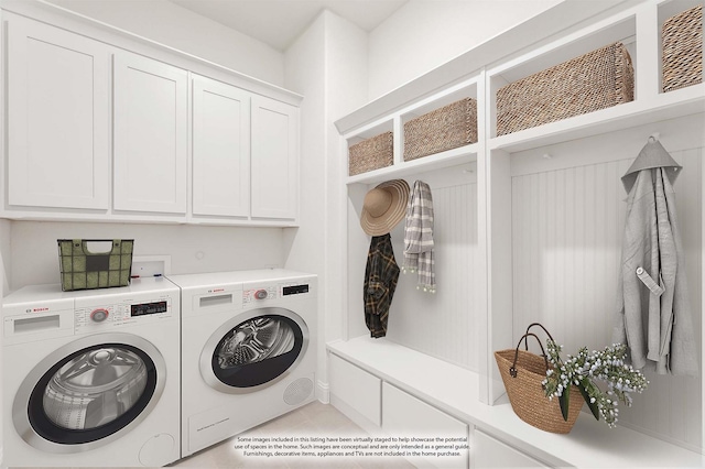 washroom with cabinets and washer and dryer