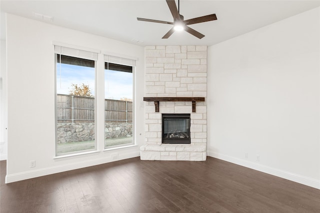 unfurnished living room with ceiling fan, dark hardwood / wood-style floors, and a fireplace