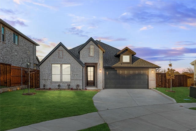 view of front of home featuring a lawn and a garage