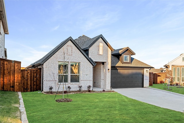 view of front of house with a garage and a front lawn