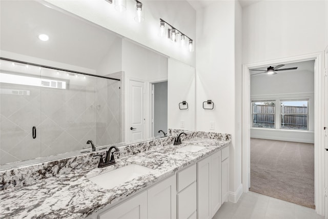 bathroom featuring lofted ceiling, tile patterned floors, a shower with door, and vanity