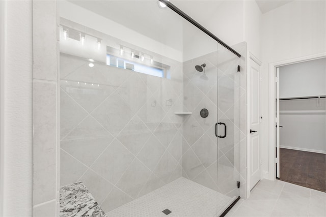 bathroom featuring tile patterned flooring and a shower with shower door