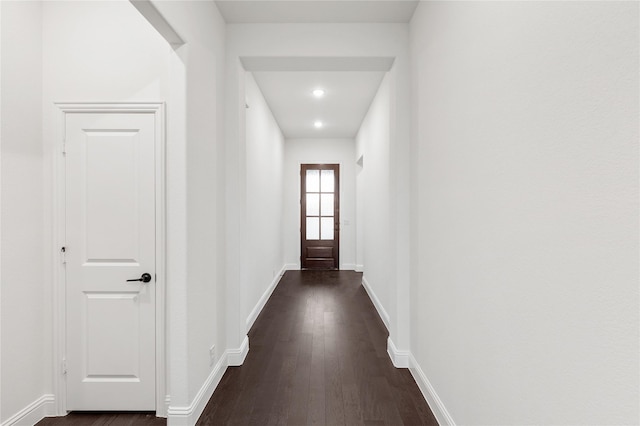 corridor featuring dark hardwood / wood-style floors