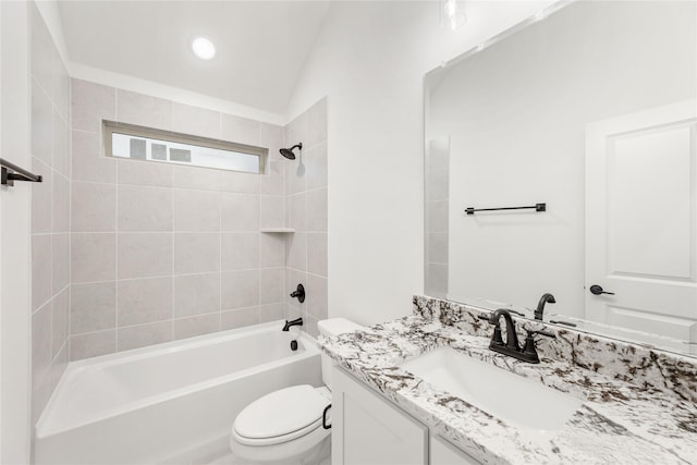 full bathroom with tiled shower / bath, vanity, and toilet