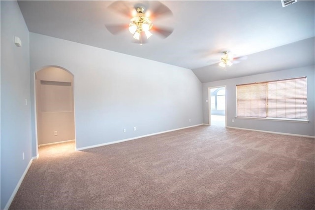 carpeted empty room with ceiling fan and vaulted ceiling