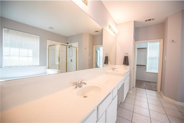 6321 Bear Run Rd, The Colony, TX 75056 - bathroom with double vanity, tile patterned flooring, a stall shower, and baseboards