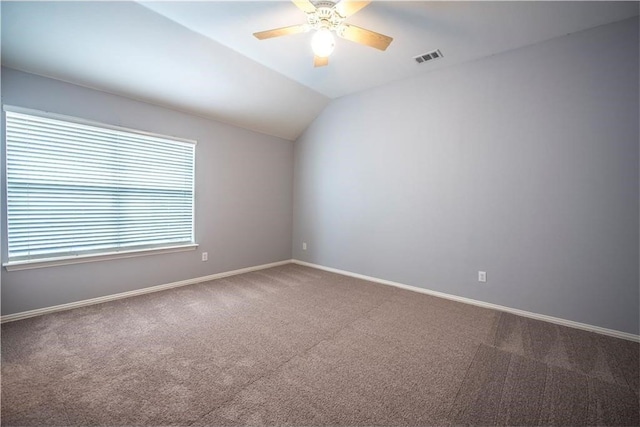 carpeted empty room featuring lofted ceiling and ceiling fan