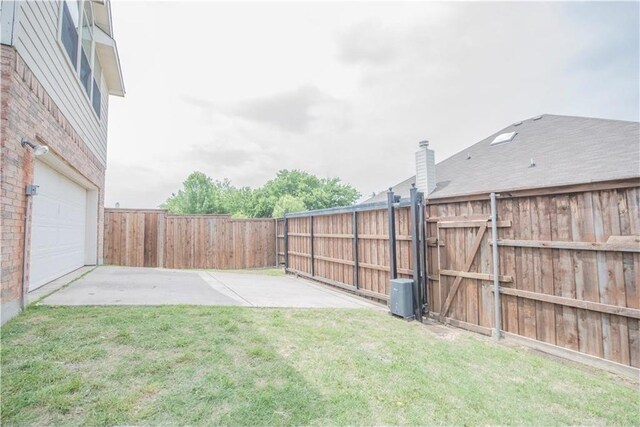 view of yard with a patio and a garage