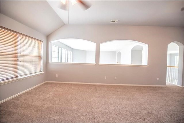 carpeted empty room with lofted ceiling and ceiling fan