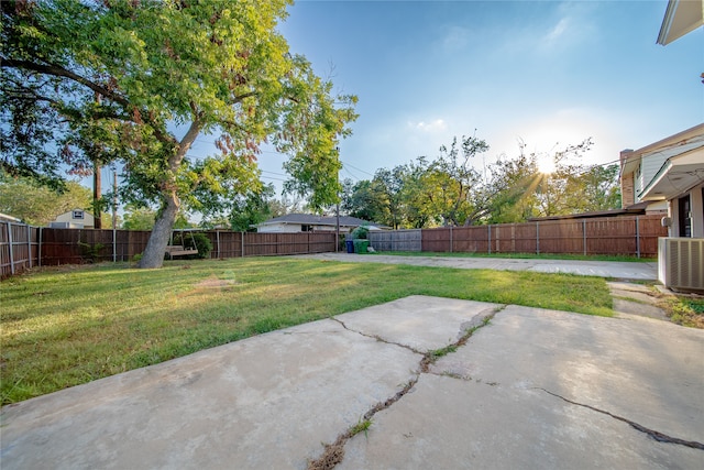 view of yard with a patio and central air condition unit